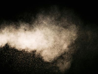 Abstract visual representing airflow and breathing with soft light particles.